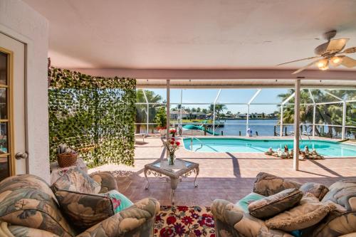 a living room with a couch and a swimming pool at Villa Sweet Dreams, Cape Coral in Cape Coral