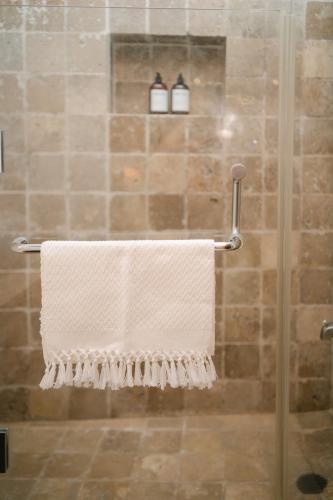a towel hanging on a towel rack in a shower at Boutique Villa in Antigua in Antigua Guatemala