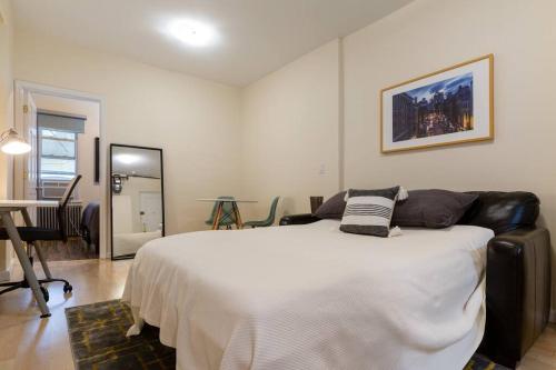 ein Schlafzimmer mit einem großen weißen Bett in einem Zimmer in der Unterkunft Large Queen Bed Apt with Workstation in New York
