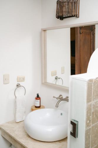 a bathroom with a white sink and a mirror at Boutique Villa in Antigua in Antigua Guatemala