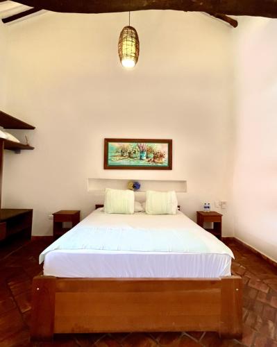 a bedroom with a bed in a room at Misia Custodia Hotel Boutique in Barichara