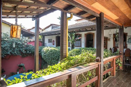 a porch of a house with a wooden fence at Pousada Marendaz in Paraty