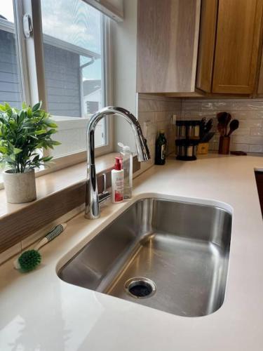 a stainless steel sink in a kitchen with a window at Post Falls Hideaway New 4 Bedroom Home Short Term in Post Falls