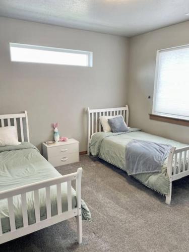 a bedroom with two beds and a window at Post Falls Hideaway New 4 Bedroom Home Short Term in Post Falls
