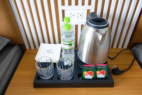 a tray with a coffee maker and cups on a table at Royal Homestay - Royal Center in Móng Cái