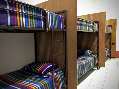 a group of bunk beds in a room at Huitzilin Hostal in Brisas de Zicatela
