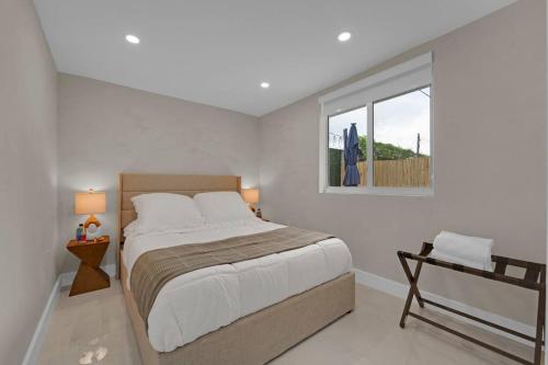 a bedroom with a large bed and a window at Casa Copal: Relaxing Beach House in Hollywood