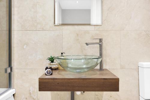 a bathroom with a glass bowl sink on a counter at Luxury 3 bedroom house in Limehouse, close to city! Sleeps 6-8! in London