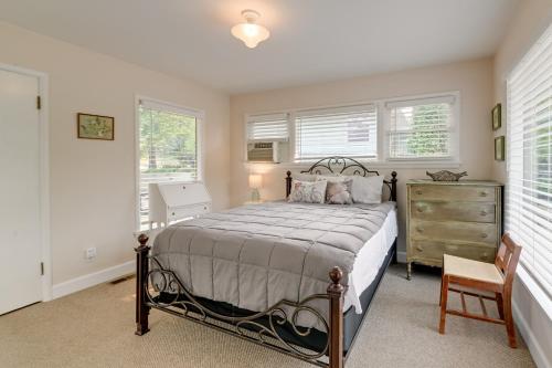 a bedroom with a bed and a dresser and windows at Grants Pass Getaway with Expansive Deck! in Grants Pass