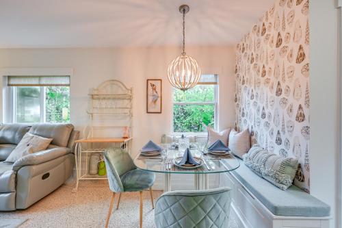 a living room with a table and a couch at Sunny Florida Escape with Patio, Grill and Fire Pit! in Naples