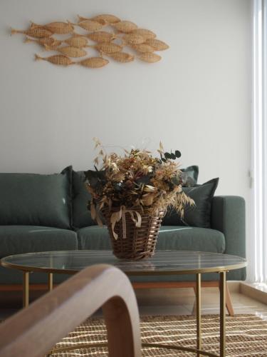 a living room with a couch and a table with a plant at HOTEL BOUTIQUE VILAVELLA in O Grove