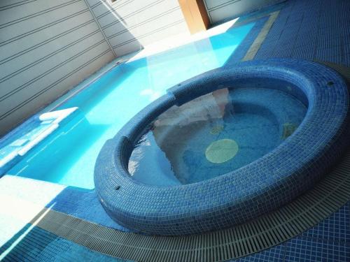 a large tire sitting in a swimming pool at Al Arda Avenue in Tashkent