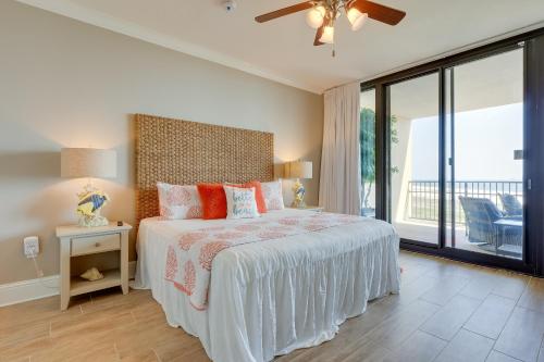 a bedroom with a bed and a large window at Dauphin Island Condo in Holiday Isle with Balcony! in Dauphin Island