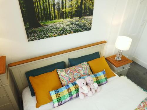 a bed with two teddy bears sitting on it at Apartment - Sleeps 5 & On-site Parking in Newport