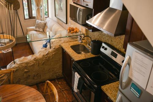 a small kitchen with a stove and a sink at Boutique Villa in Antigua in Antigua Guatemala