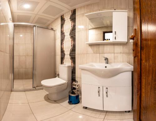 a bathroom with a toilet and a sink and a shower at Gul Otel in Istanbul