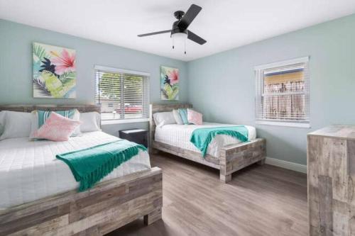 a bedroom with two beds and a ceiling fan at Saltwater pool, FREE beach passes & GREAT location! in Boynton Beach