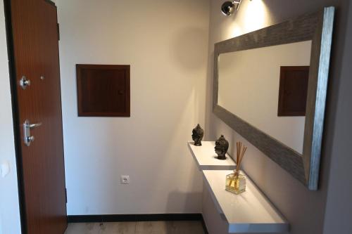 Un baño con lavabo y un espejo grande. en Apartamento Quinta Nova, en Alvor