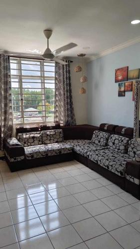 a living room with a couch and a window at Rumahku in Kota Kinabalu