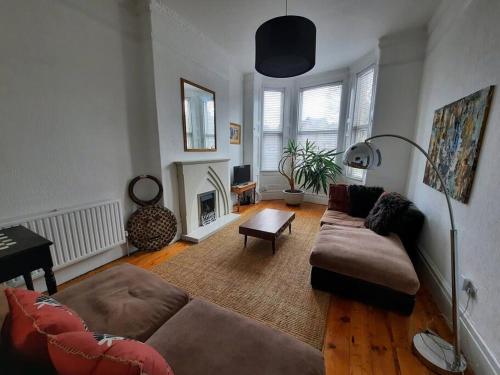 a living room with a couch and a fireplace at Anfield Haven in Liverpool