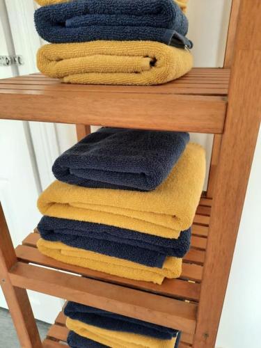 a pile of towels sitting on a towel rack at Anfield Haven in Liverpool