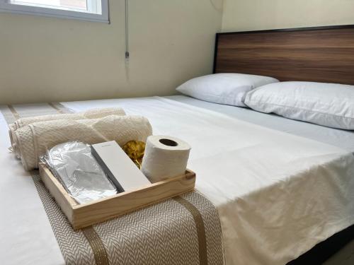 a bed with a tray with toilet paper on it at Condotel Room to Stay Lodging in Manila