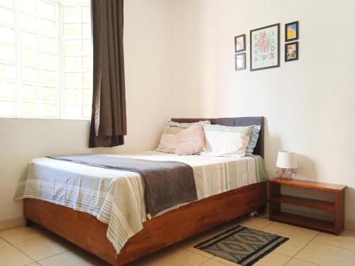 a bedroom with a large bed with a window at Suíte com banheiro super espaçosa in Sao Paulo