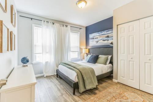 a bedroom with a bed and two windows at Next to Convention Center, Dave and Busters and Shops with parking in Atlantic City