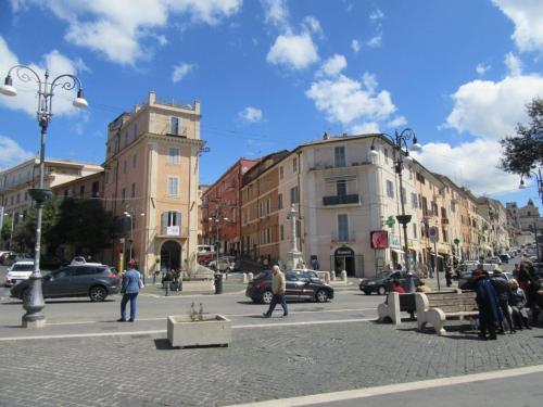 a city street with buildings and people walking on the street at Casa vacanza l’archetto in Genzano di Roma