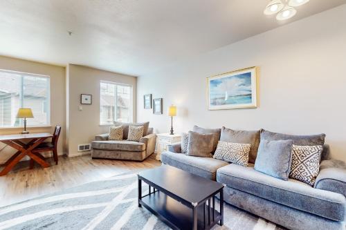 a living room with a couch and a table at Siuslaw Sanctuary in Florence