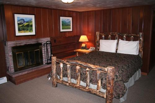 a bedroom with a large bed and a fireplace at Timber Creek Chalets- 14 chalet in Estes Park