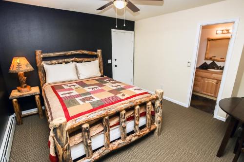 a bedroom with a bed with a wooden frame at Fawn Valley Inn- 294 condo in Estes Park
