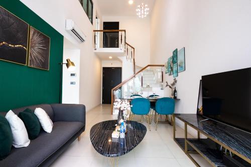 a living room with a couch and a table at DingD0ng Home FelizEnVista 5-star facilities in Ho Chi Minh City