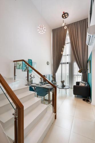 a staircase in a living room with a table at DingD0ng Home FelizEnVista 5-star facilities in Ho Chi Minh City