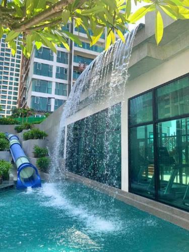 a pool with a water slide in front of a building at DingD0ng Home FelizEnVista 5-star facilities in Ho Chi Minh City