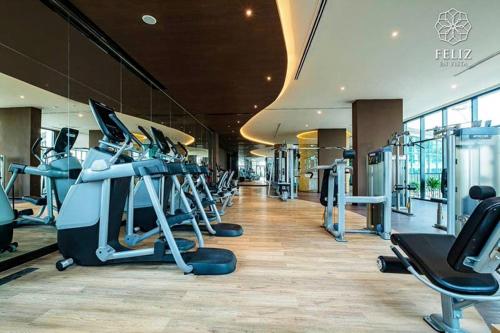 a gym with treadmills and machines in a building at DingD0ng Home FelizEnVista 5-star facilities in Ho Chi Minh City