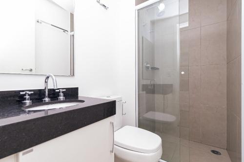 a bathroom with a toilet and a sink and a shower at Vossa Bossa VN Turiassu in Sao Paulo