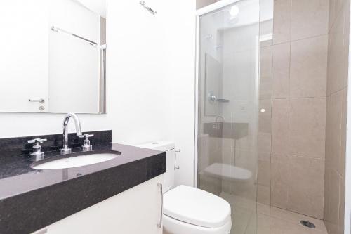 a bathroom with a toilet and a sink and a shower at Vossa Bossa VN Turiassu in Sao Paulo