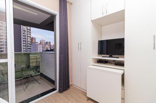 a room with a large window with a view of a city at Vossa Bossa VN Turiassu in Sao Paulo