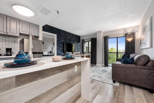 a kitchen and living room with a couch at Apartment with Volcano Bay view in Orlando