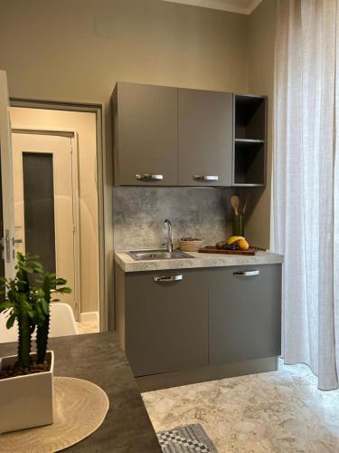 a kitchen with a sink and a counter top at Visconti 90 in Bari