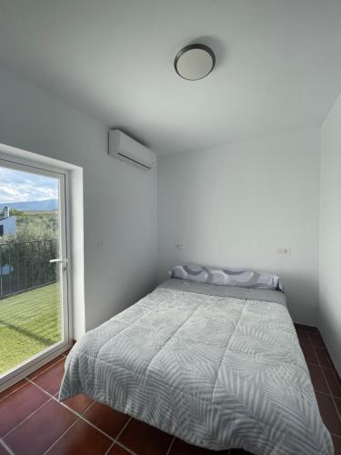 a bedroom with a bed and a large window at Casa Martínez in Baza