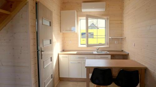 a small kitchen with a sink and a window at Fe / Ha STAR- SUNNY RELAX in Bobolin