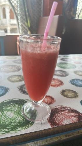 a drink in a glass sitting on a table at IL Padrino hotel in Pushkar