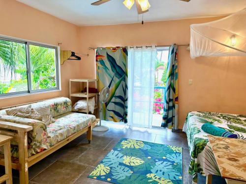 a living room with a couch and a window at Cabarete Boutique Kite Hotel for up to 15 people in Cabarete