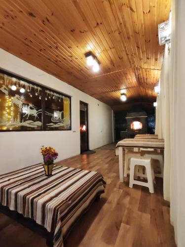 a room with two tables and a table with flowers at Карпатський куточок in Slavske
