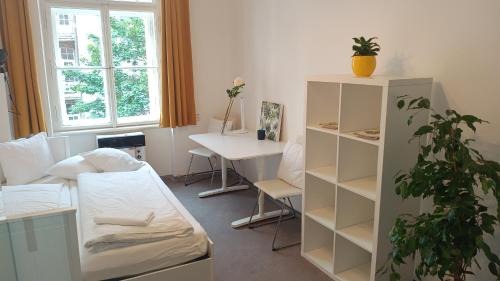 a room with a bed and a desk and a table at Apartments in Mala Strana - 10 minutes from Charles Bridge in Prague