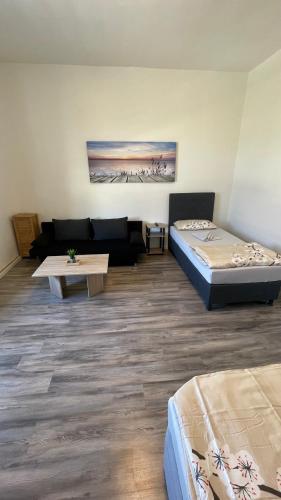 a living room with two beds and a couch at Apartment am Zollverein -WiFi - Parking for free in Essen