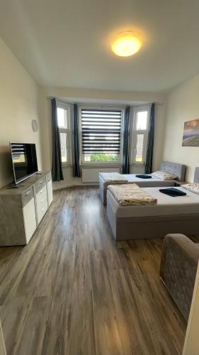 a large room with two beds and a flat screen tv at Apartment am Zollverein -WiFi - Parking for free in Essen