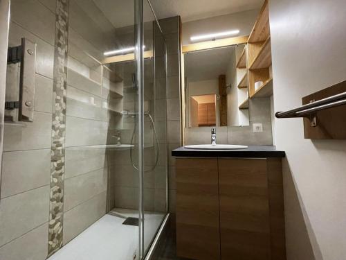 a bathroom with a glass shower and a sink at Studio Les Menuires, 1 pièce, 4 personnes - FR-1-452-195 in Les Menuires
